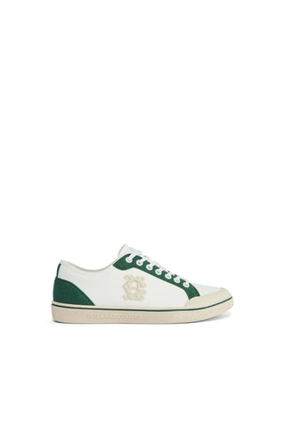 White sneaker with green accents on a white background