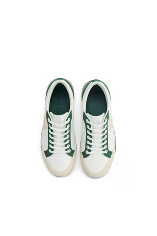 White sneakers with green accents on a white background